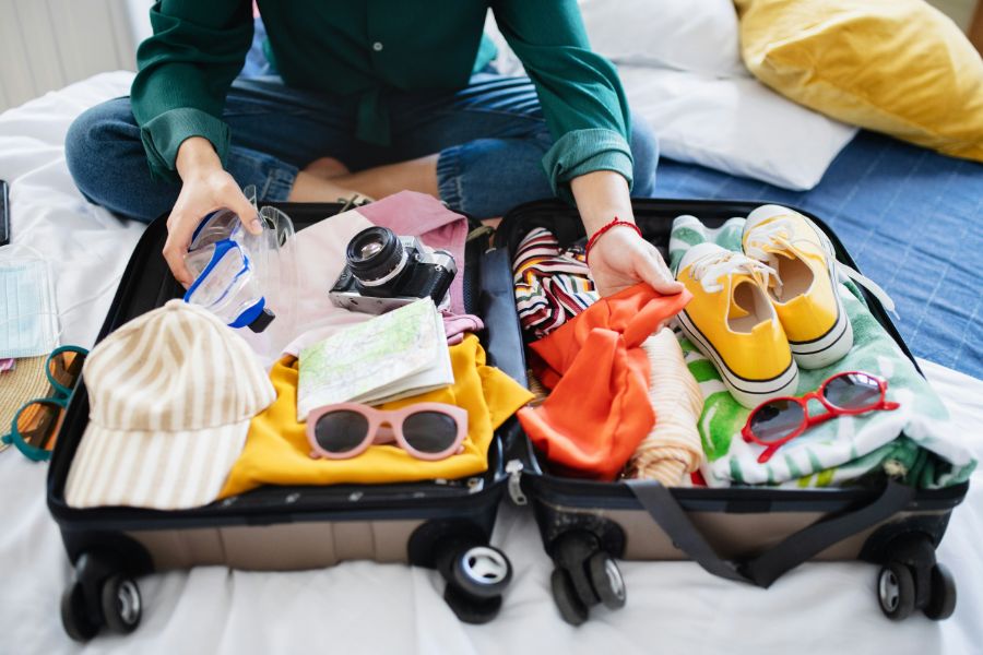 An open suitcase packed for travel.