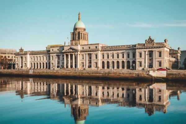 white concrete building beside a body of water in Dublin, Ireland