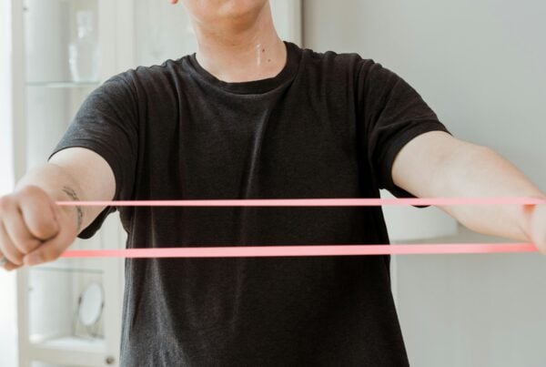 A patient using an elastic band to stretch in Italy.