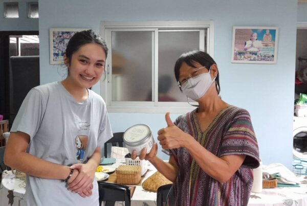An intern posing for a picture with a patient during her occupational therapy placement in Thailand.