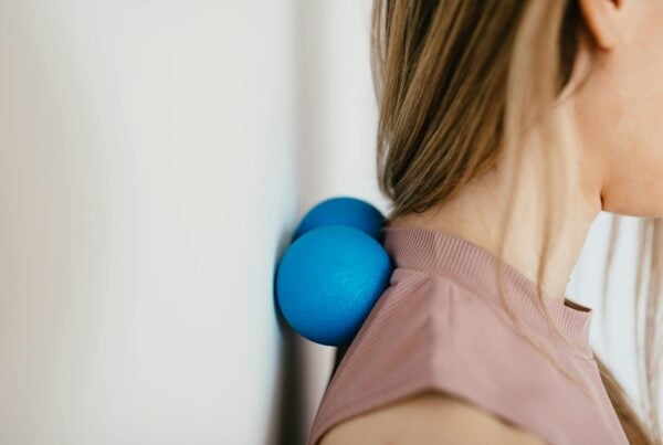 A patient performing an exercise for her upper-back.