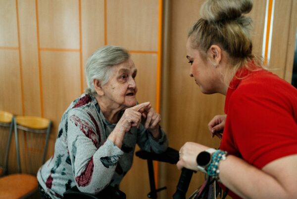 An intern assisting an elderly lady during her occupational therapy placement in Costa Rica.