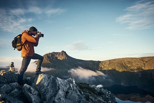 in-text image 10 a young man taking photographs while hiking in the mountains