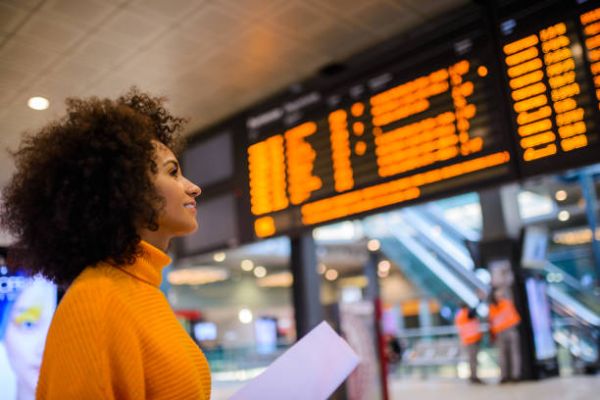 in-text image 4 A woman at the train station checking the departure board