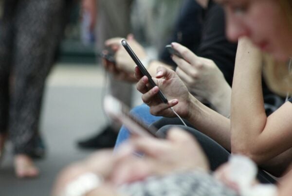 several people looking at smartphones