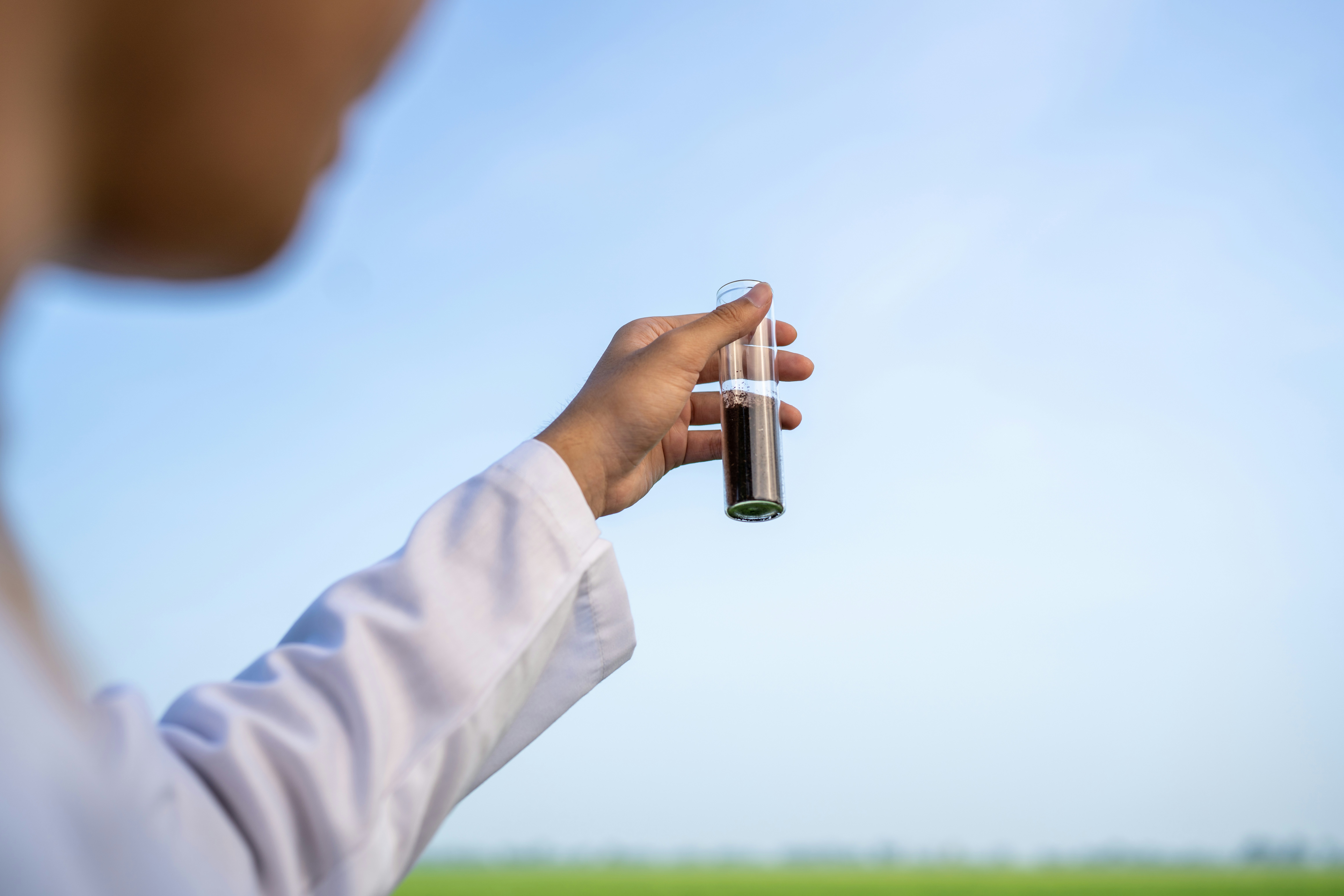 person holding vial