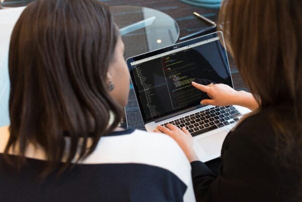 two women looking at a laptop screen