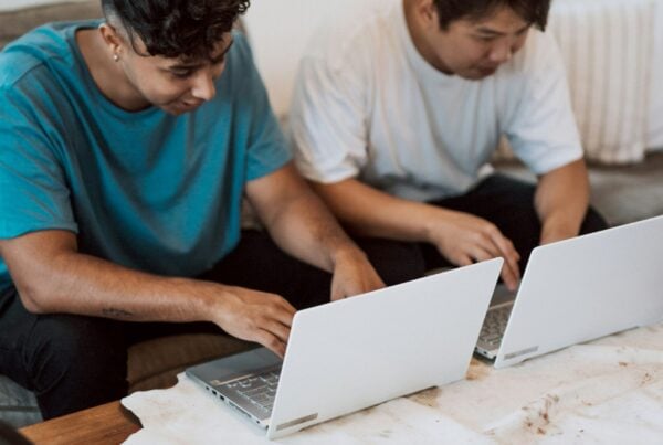 two people working on laptops