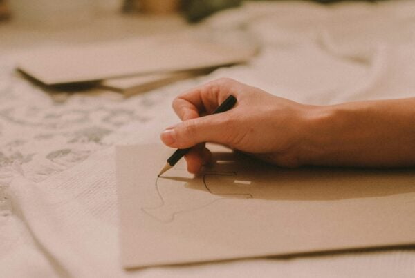hand writing with pencil on paper