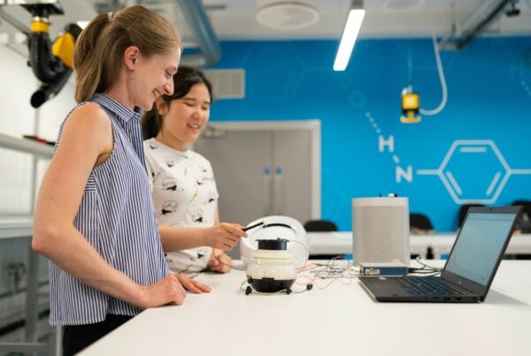 two women working on a robot