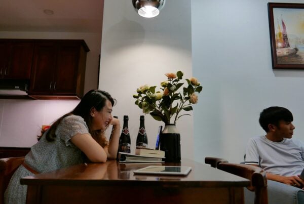 two people in a combined kitchen and living space