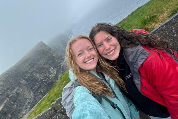 Two interns standing near a cliff edge.