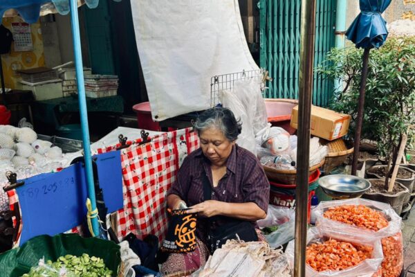 A woman selling food at a street booth.