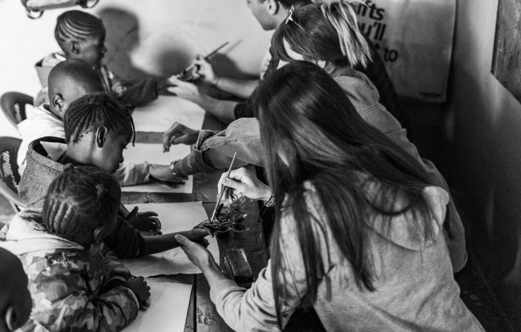 Volunteer interacting with children during a childcare and teaching placement abroad